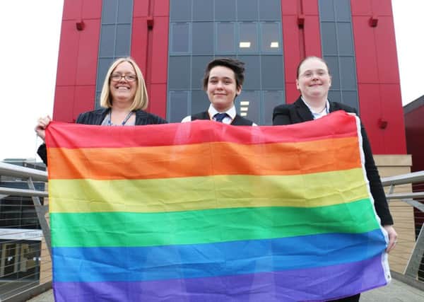 Flying the rainbow flag for West Nottinghamshire College are (from left) vice-principal Louise Knott, student representative Alex Belcher and staff representative Jane Hawksford.