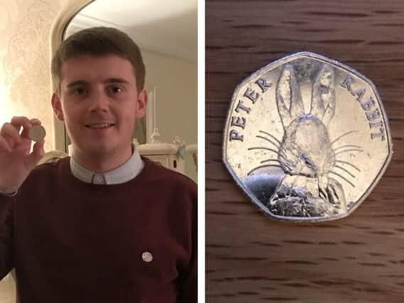 Caolan McGinley, pictured with the coin he found