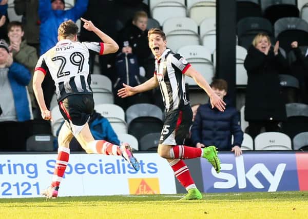 Grimsby Town's Calum Dyson celebrates his second goal with team mate Sam Jones - Photo by Chris Holloway