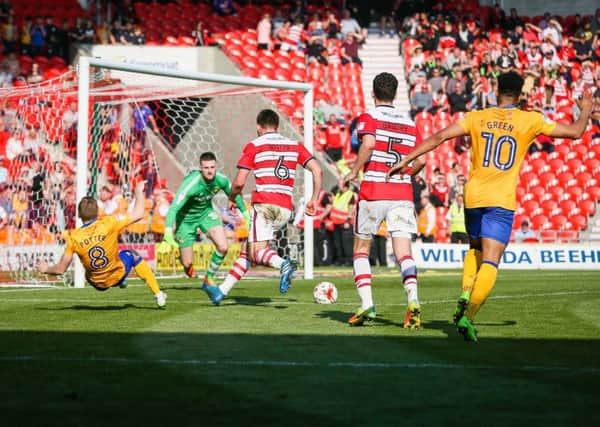 Mansfield Town's Alfie Potter goes down in the Doncaster penalty area - Photo by Chris Holloway