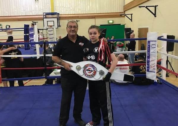 Lucie Callan pictured here being presented with her world title belt from English WKU president Paul Sutton