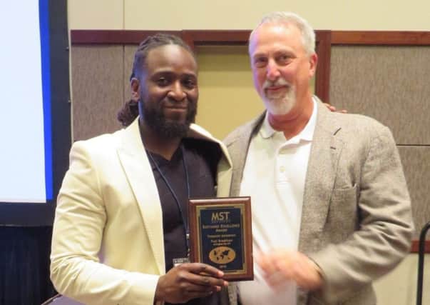 Fuzi Bradshaw receives the ESSY Award from Dr Scott Hengeller