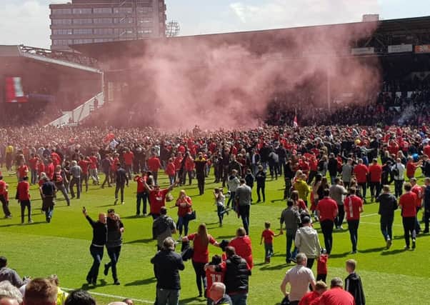 Fans run on to the City Ground pitch after Forest avoid relegation on the last day of the season. Pic by John Lomas.