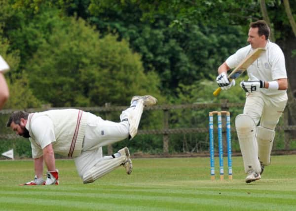 Anston wicketkeeper James Matthew King takes a tumble as Papplewick and Linby batsman Sam Ogrizovic collects more runs
