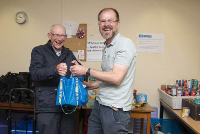 Hucknall Food Bank, Alan Porter from Kings Family Church drops off some donated food to administrator Ed Rippon