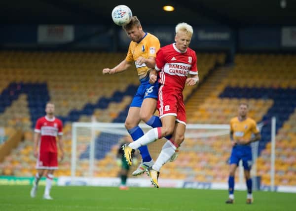 Mansfield Town vs Middlesborough - Joel Byrom wins a header - Pic By James Williamson