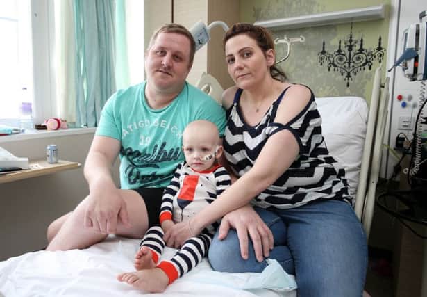 Dawson Willcock in hospital with parents David and Wendy.