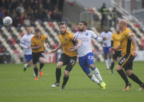 Kane Hemmings of Mansfield Town is sandwiched between Mark O'Brien and David Pipe of Newport County during the Sky Bet League 2 match between Newport County and Mansfield Town at Rodney Parade, Newport, Wales on 21 October 2017. Photo by Mark  Hawkins / PRiME Media Images.