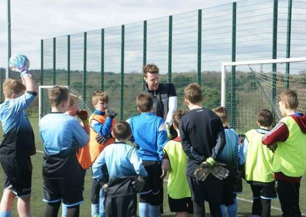 Adam giving some advice to youngsters at one of his coaching sessions.