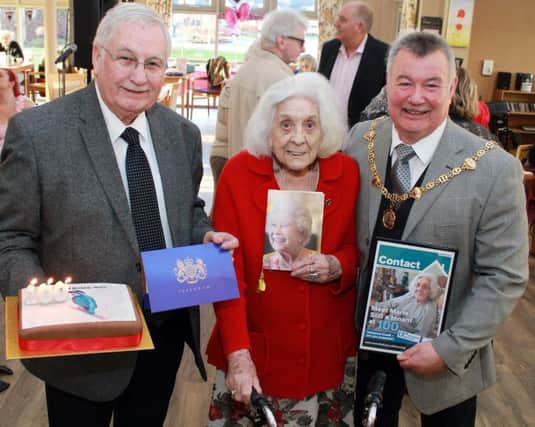Marie Rowley the oldest resident at Poppy Fields Extra Care sheltered housing complex, Marie celebrated reaching her centenary with a surprise party on 17 January. Left to right: Mansfield District Council Portfolio Holder for Housing, Cllr Barry Answer, with Marie's telegram from Esther McVey, Secretary of State for Work and Pensions; Marie Rowley, holding her card from the Queen; Cllr Kevin Brown, Chairman of Mansfield District Council, holding a framed front cover of Contact magazine for council tenants