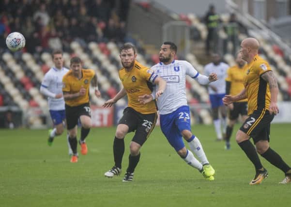 Kane Hemmings of Mansfield Town is sandwiched between Mark O'Brien and David Pipe of Newport County during the Sky Bet League 2 match between Newport County and Mansfield Town at Rodney Parade, Newport, Wales on 21 October 2017. Photo by Mark  Hawkins / PRiME Media Images.