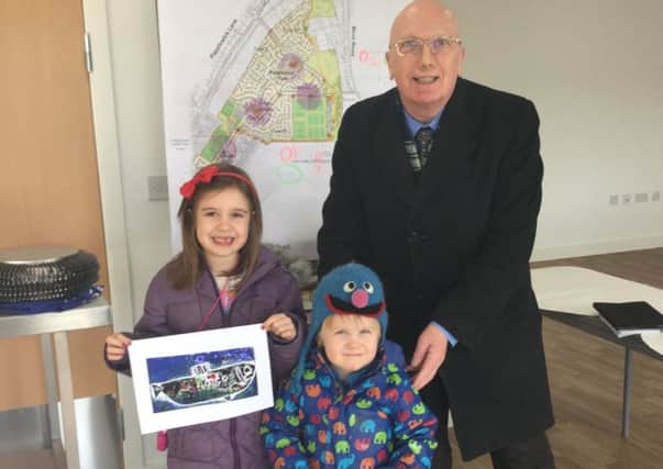 Art initivative at Papplewick Green estate, Hucknall. Hucknall Independent councillor John Wilmott  and six year old Lennon Davies talk  to sculptor Michael Johnson about the project.