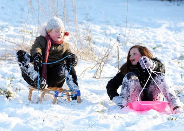 Sledging on the Millenium Green gets the approval of Mansfield Woodhouse youngsters on Wednesday.