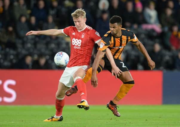 Fraizer Campbell and Joe Worrall challenge for the ball.