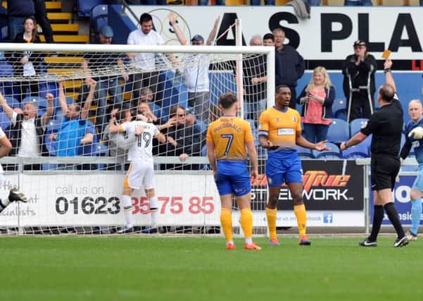 Mansfield Town v Port Vale.   
Krystian Pearce is yellow carded after Port Vale's equaliser.