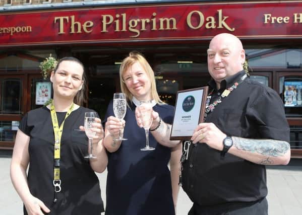Manager Emily Hawkley (centre) and staff members Rosie Briggs and Tony Cole toast The Pilgrim Oak's success. (PHOTO BY: Jason Chadwick)