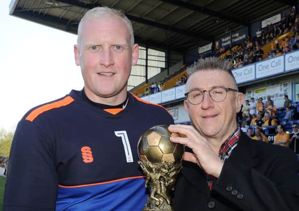 Mansfield's Conrad Logan is presented with the Chad Player of the Year by John Lomas